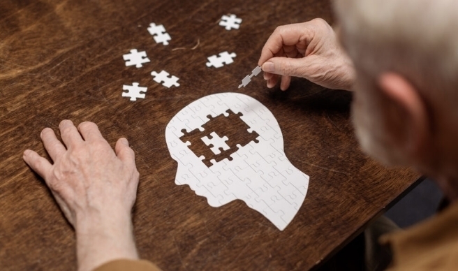 person creating puzzle of head